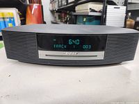 Front view of Bose CD player with digital display showing track and time information.