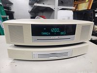 Front view powered on showing digital display (12:00) with “CD Track 003” and Bose badge