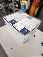 Photo of closed case box with two boxes of Business Source copy paper inside