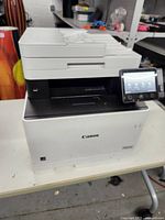 Front angled view of Canon Color ImageCLASS multifunction laser printer showing touchscreen and document feeder.