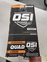 Black and orange OSI QUAD box showing brand and product details.