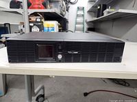 Front view of the CyberPower UPS with LCD display and power button.