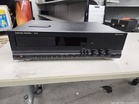 Front view showing the whole cassette deck unit with buttons, knobs, and display panel.