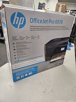 Box front of HP OfficeJet Pro 6978 with product features and image