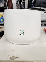 Front view of white Lomi kitchen composter with power and mode controls visible.