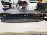 Front view of the Pioneer Elite Blu-ray Disc Player showing brand and model with 'POWER ON' on the display.