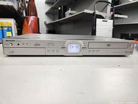 Front view of Sharp HDD/DVD recorder model DV-NC808 with power on and channel display shown.