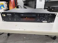 Front view of Tascam MD-301MK II MiniDisc recorder showing control panel, digital display, and power switch.