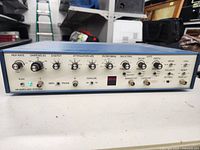 Front panel view showing all control knobs and labels with power light on.