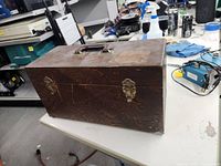 Closed wooden box with handles and latches on a table in a workshop