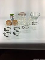 Photo showing all items including Bodum glass cups and saucers, glass jars with cork lids, large glass jar with metal clasp lid, glass mixing bowl, and ceramic mug