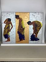 Front view of the signed canvas artwork centered on a table with a white backing cloth beneath.