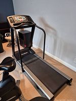 Assembled treadmill in room next to stationary bike