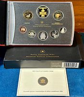 Top view of 2006 Canadian Proof Coin Set with reverse sides displayed including special $2 Victoria Cross coin, housed in transparent plastic case inside black folder.