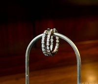 Front angle view of hoop earrings showing double row of CZ stones on gold-plated sterling silver hoops.