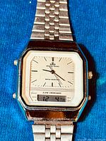 Close-up image of the watch face showing analog time and digital display with the Meister Quarz logo visible.