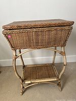 Side view of the medium brown rattan side table showing woven top, curved legs, and lower shelf.