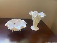 Two piece set of Fenton milk glass hobnail bowl and vase displayed on wooden surface.