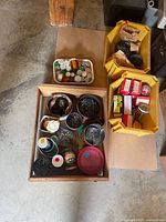 Overview of wooden box with assorted nails and fasteners in containers and jars.