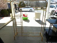 Front view of metal clothes rack showing hanging rod and shelving unit.