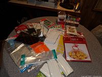 Photo showing various food gift bags, clear packaging bags, cookie treat kit, and supply items on table.