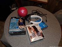 Lot contents showing personal muscle massager, weighted exercise ball, total toning kit, and neck and shoulder wrap.