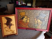 Wooden wall pictures showing eagle and two men toasting