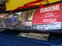 Photo of the tent stored in its official Coleman Sundome carrying bag showing branding and product features.