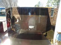 Front view of the wall mounted electric fireplace showing the reflective black glass surface.