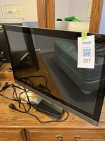 Front view of HP Pavilion all-in-one computer with power adapter and cables on tabletop