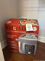 Box showing Instant Pot Duo Plus Multi-Cooker, 9-in-1, indicates new in box condition and 8-quart size.