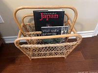 Front view of bamboo magazine rack containing two books: 'A Day in the Life of Japan' and 'Small Space Gardening'