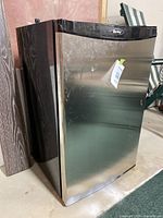 Frontal view of Danby mini fridge showing stainless steel door and black trim.