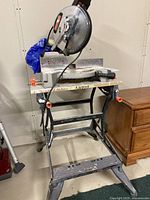 Front view of Craftsman mitre saw mounted on Black and Decker Workmate 200 stand, showing overall setup and condition