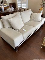 Front view of sofa showing overall upholstery and cushion arrangement