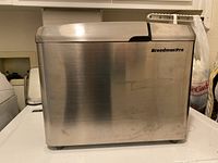 Side view showing stainless steel body with Breadman Pro branding.