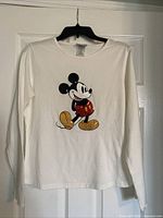 Full front view of white long sleeved t-shirt with classic Mickey Mouse image