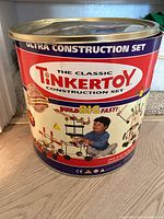 Front of the large round metal container labeled The Classic Tinkertoy Ultra Construction Set
