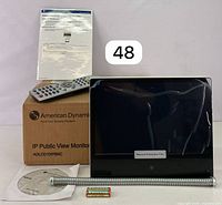 Monitor with protective film, remote, manual, box, software CD, mounting hardware, and batteries.