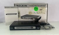 Belkin OmniView PRO3 4-Port KVM switch unit with original box, cables, and manual.