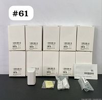 Set of 10 boxed Visonic MCT-370 SMA wireless magnetic door/window sensors with accessories (screws, anchors, manual) laid out in front