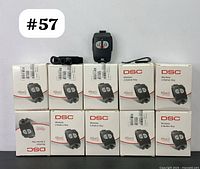 Set of 10 DSC PG8949 wireless panic buttons in original boxes, one button out of box displayed