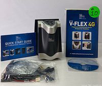 Full lot showing V-FLEX 4G device with quick start guide, box, CD, and wiring harness kit.