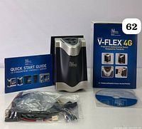 Front view of the L1 Identity Solutions V-FLEX 4G device showing logo and sensor with quick start guide, cables, software CD, and box.
