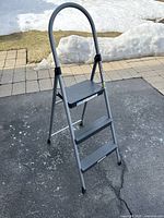 3 step folding step ladder fully opened, showing three wide anti-slip steps and curved handgrip for support.
