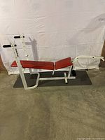 Full side view of the Weider adjustable weight bench showing red padded bench and main steel frame