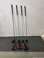 Four Callaway golf woods including Big Bertha FT-3 driver and three FT-I woods 3, 5, and 7, lined up with their matching head covers on the floor.