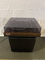 Front view of Pioneer turntable on stand with dust cover closed