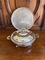 Photo showing the terrine with lid and decorated tray behind it