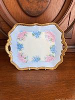 Front view of the vintage hand painted platter showing floral design and gold border.